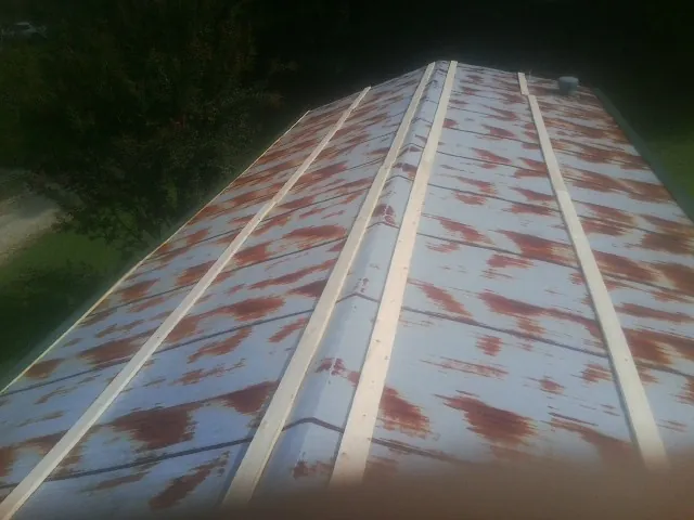 Rusted metal roof panels with new wood purlins before replacement — Storm Damage Roof Repair in Hacker Valley by Roofing Brothers